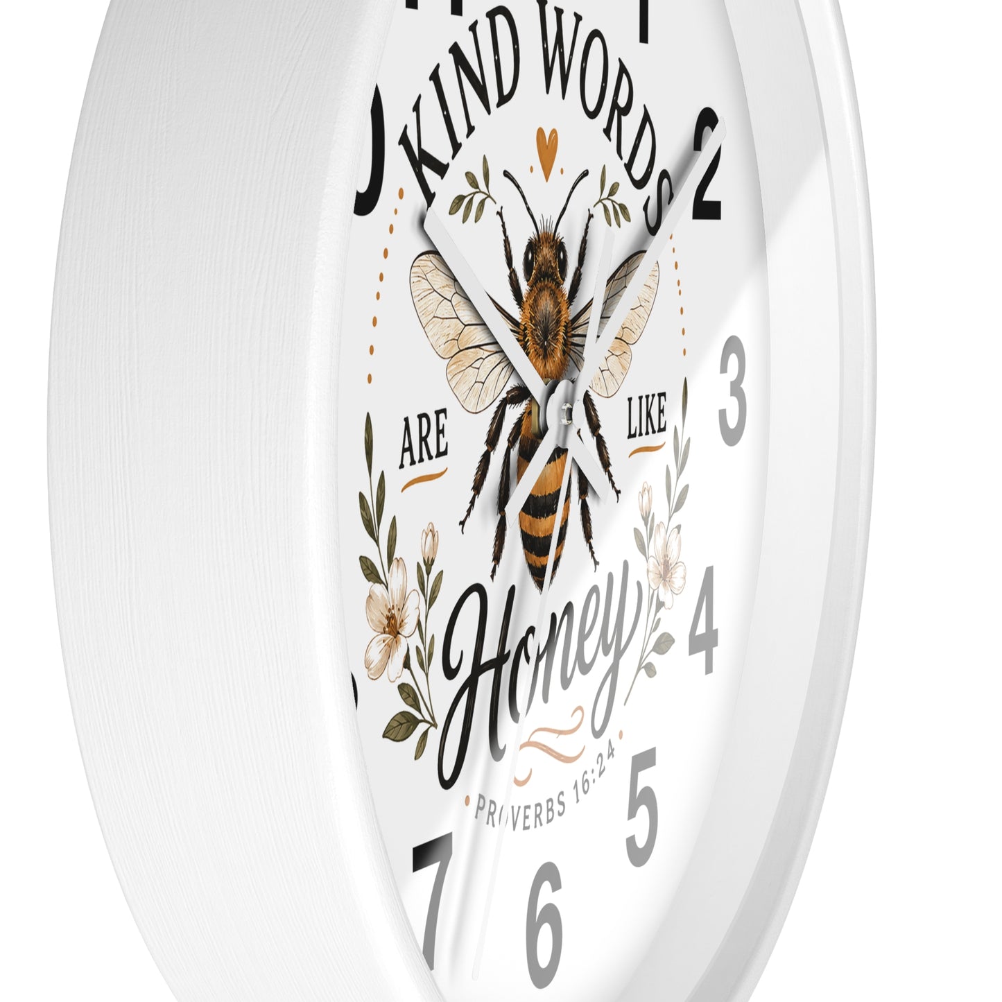 A white round wall clock with a printed bee illustration and the words 'Kind Words Are Like Honey' around the dial, shown against a plain white background.