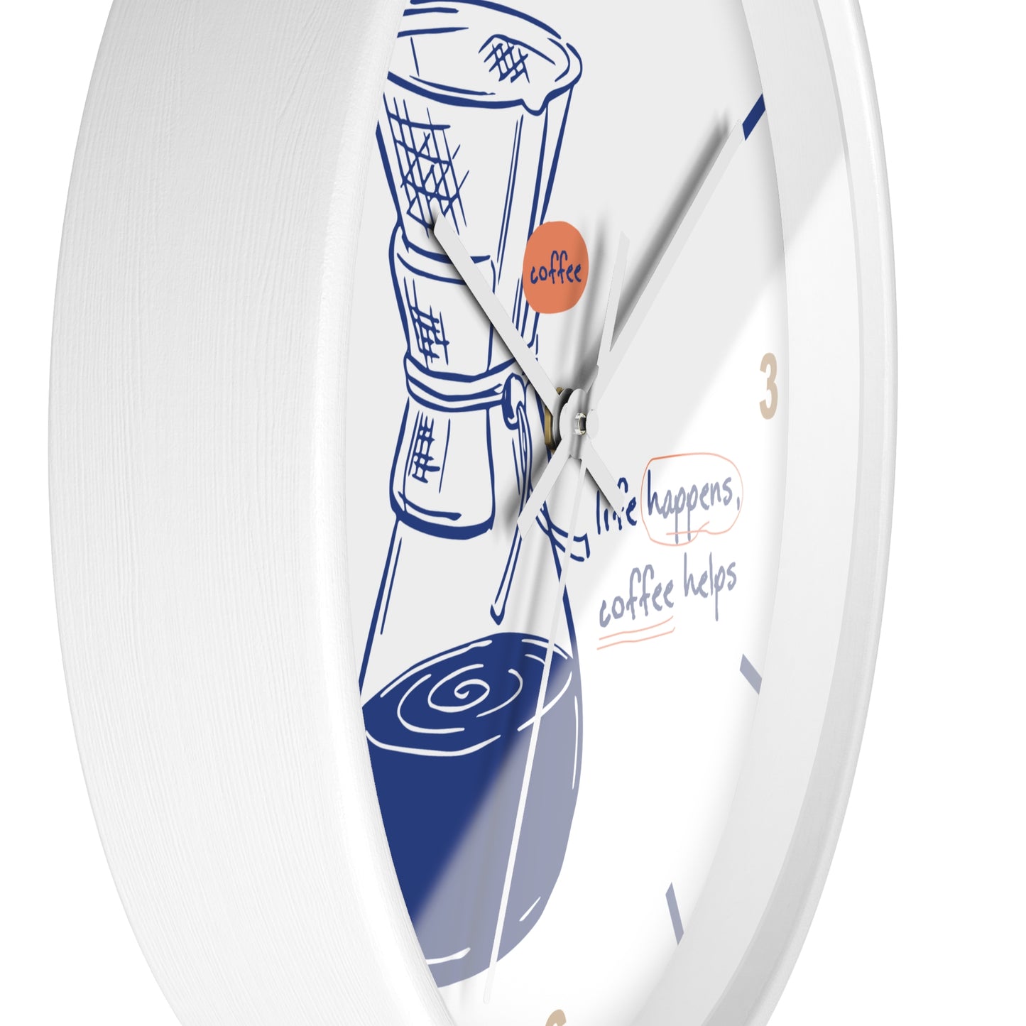 A white round wall clock with a coffee-themed design, featuring a blue line drawing of a coffee maker and cup, gold numbers, and the phrase 'life happens, coffee helps' on the dial.
