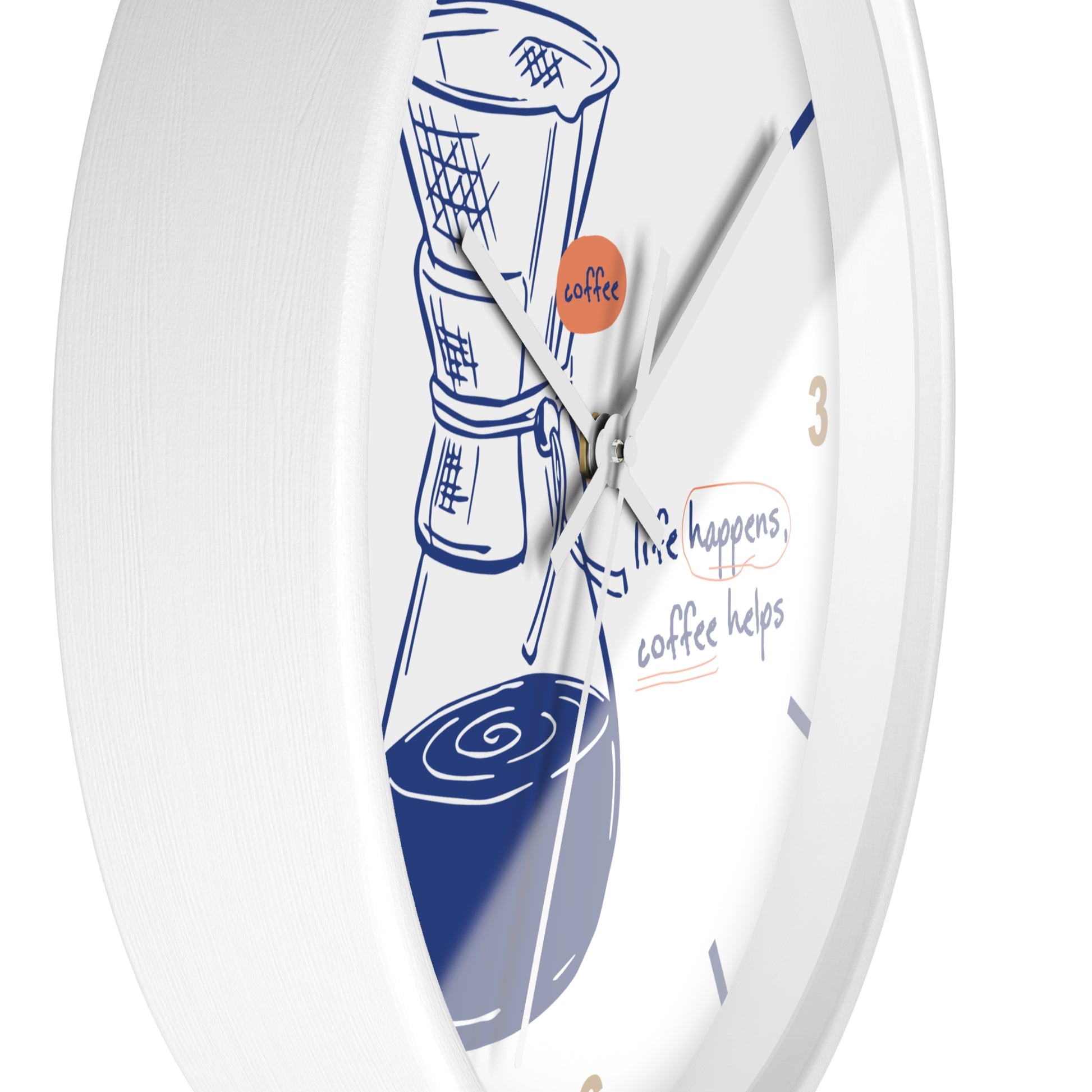 A white round wall clock with a coffee-themed design, featuring a blue line drawing of a coffee maker and cup, gold numbers, and the phrase 'life happens, coffee helps' on the dial.