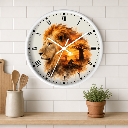 A round wall clock with a white frame and a printed lion-and-sky artwork on the face, mounted on a white subway-tile wall above a wooden shelf with a small potted plant and utensil holder.