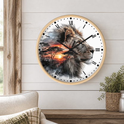 A round wall clock with a light wood frame hangs on a white shiplap wall above a wooden console table. The clock face features a detailed illustration of a lion's head in profile over a savanna sunset scene with acacia trees.