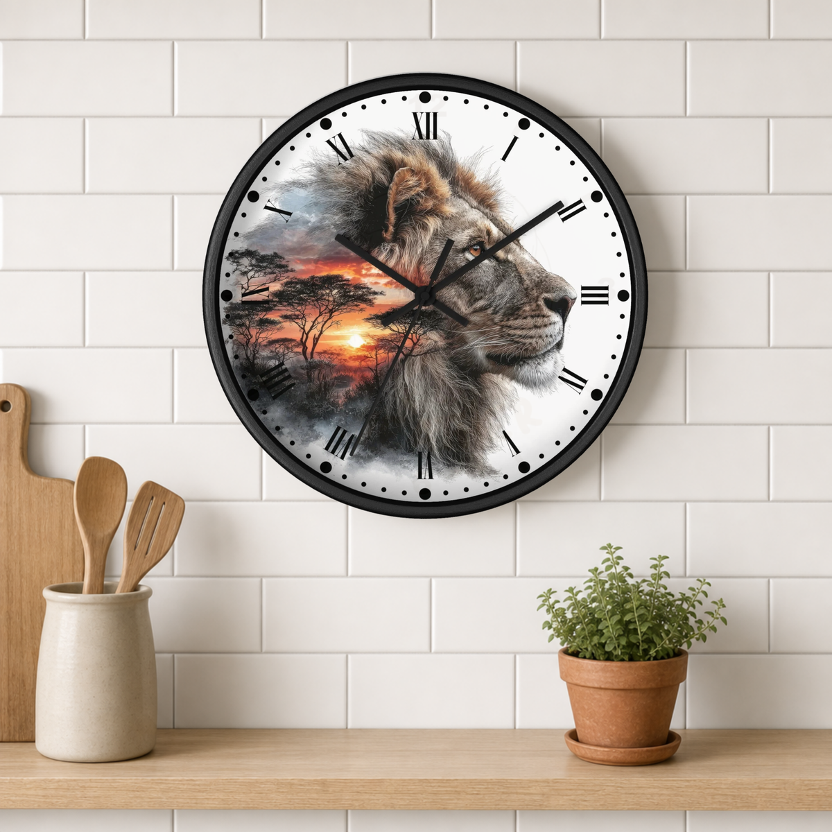 A round wall clock with a black frame hangs on a white subway-tile wall above a wooden shelf. The clock face features a detailed lion portrait over a savanna sunset scene.