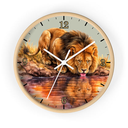 Round wall clock with a light wood frame and a printed lion drinking from water artwork on the face, shown against a plain white background.