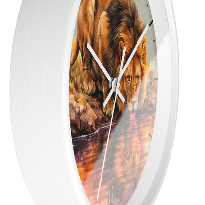 A round wall clock with a white frame and a printed lion scene on the face, showing a large brown lion over reflective water with white hands and black numerals.
