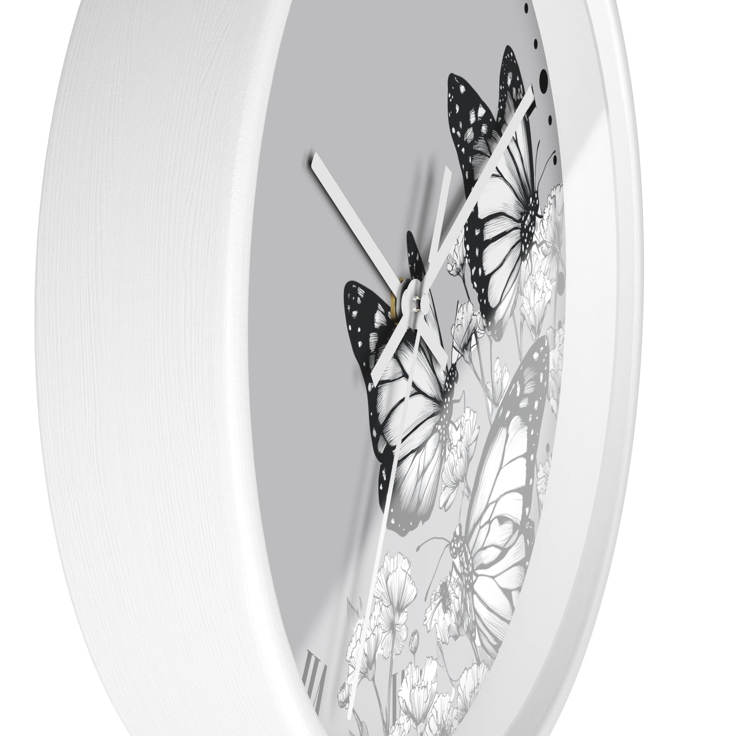 A white round wall clock with a monochrome butterfly and floral design on the dial, shown against a plain white background.