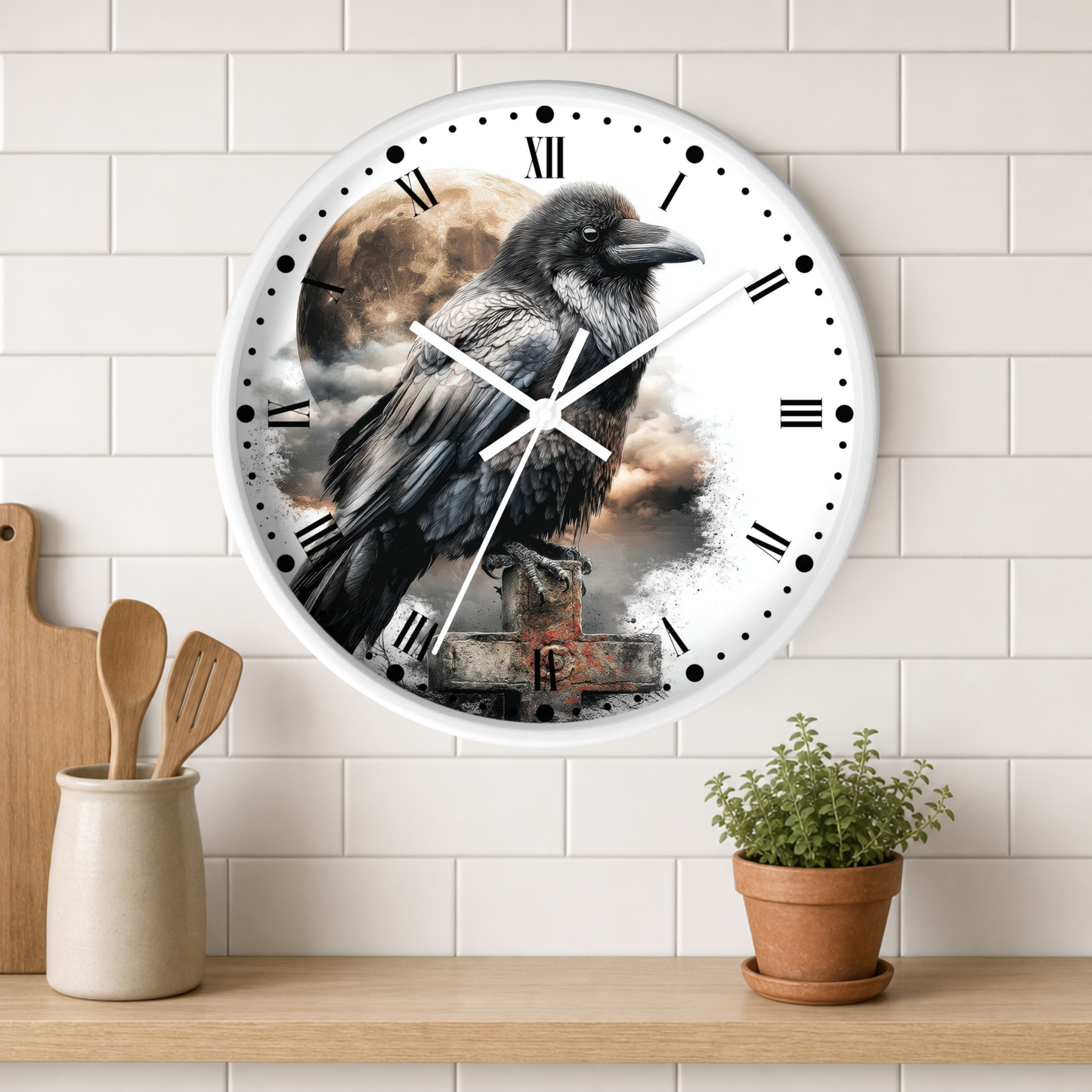 A round wall clock with a white frame and Roman numerals, featuring a raven perched over a rustic stone structure against a cloudy sky. The clock is mounted on a white subway-tile wall above a wooden shelf with a small potted plant and wooden utensils.