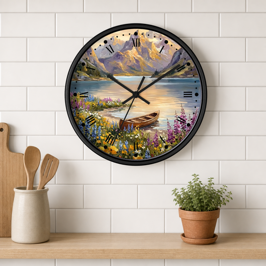 A round wall clock with a scenic mountain lake painting, mounted on a white subway tile wall above a wooden shelf with kitchen utensils and a potted plant.