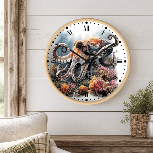 Round wall clock with a light wood frame featuring a detailed octopus and coral reef illustration, mounted on a white shiplap wall above a wooden console table with a plant.