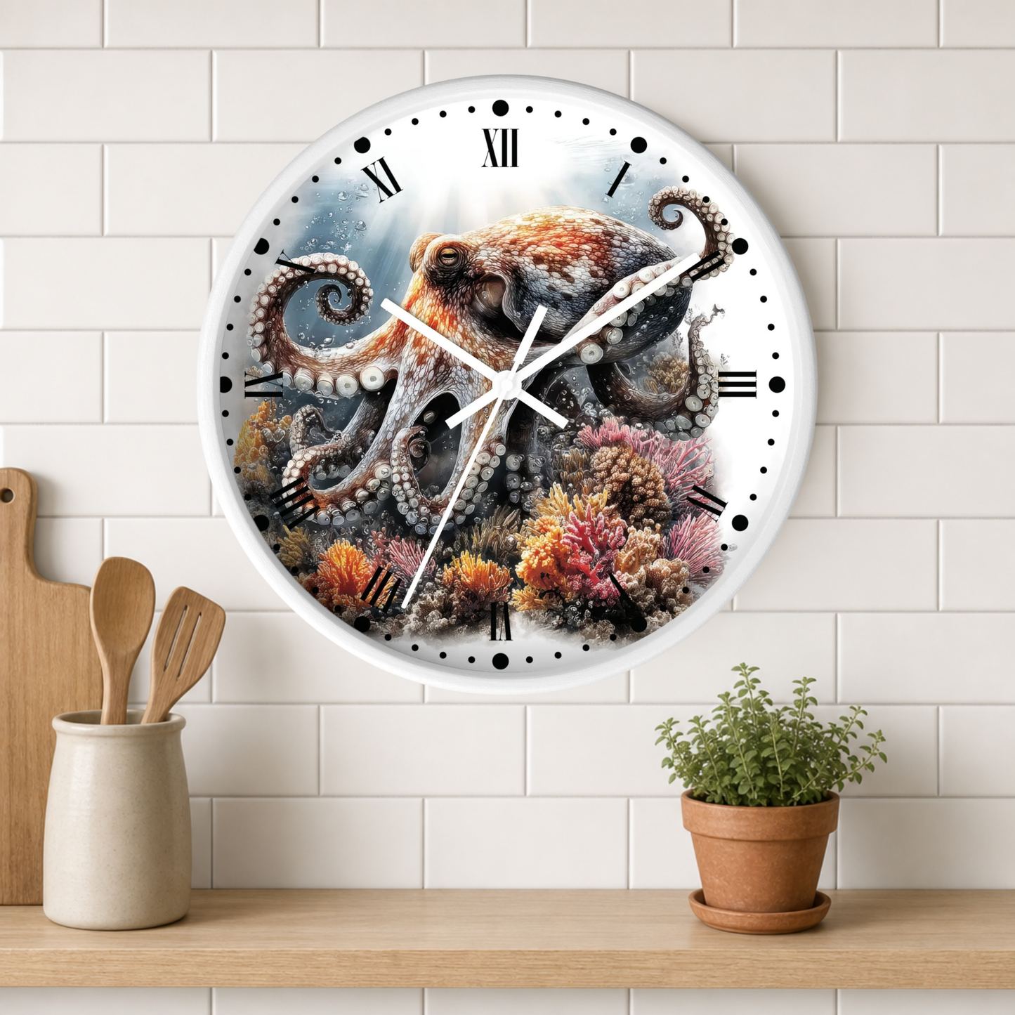 A round wall clock with a white frame and Roman numerals, featuring a detailed illustration of an octopus among colorful coral reef creatures on the face. The clock is mounted on a white subway-tile wall above a wooden shelf with kitchen utensils and a small potted plant.