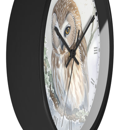 A close-up of a round wall clock with a black frame and a detailed illustration of a brown and white owl on the face, set against a plain white background.