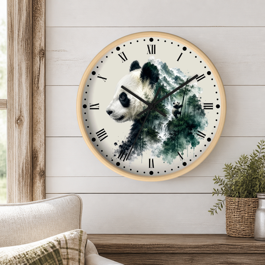 A round wall clock with a light wood frame hangs on a white shiplap wall above a wooden table. The clock face features a watercolor-style panda over green and blue ink-wash scenery, with black Roman numerals and hands.