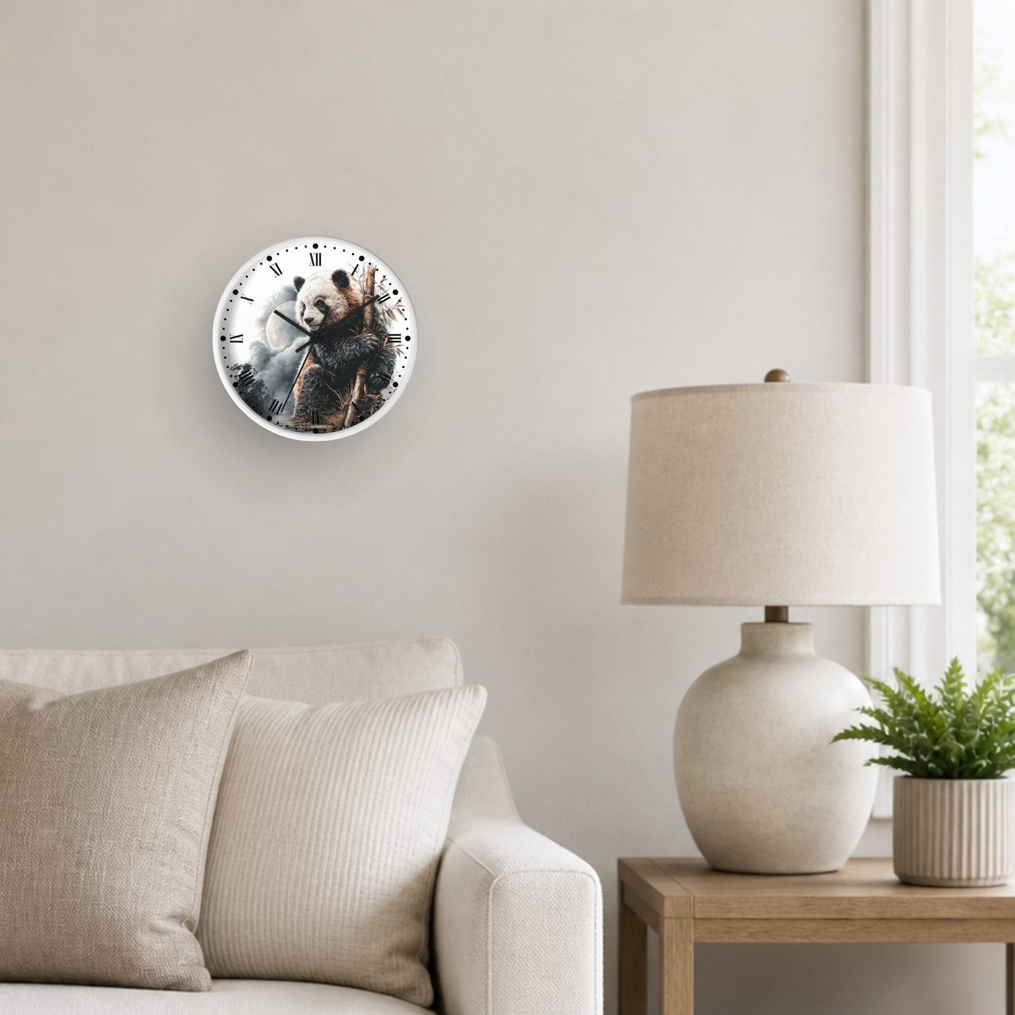 A round wall clock featuring a printed panda bear illustration, mounted on a light beige wall in a styled living room setting next to a lamp and sofa.