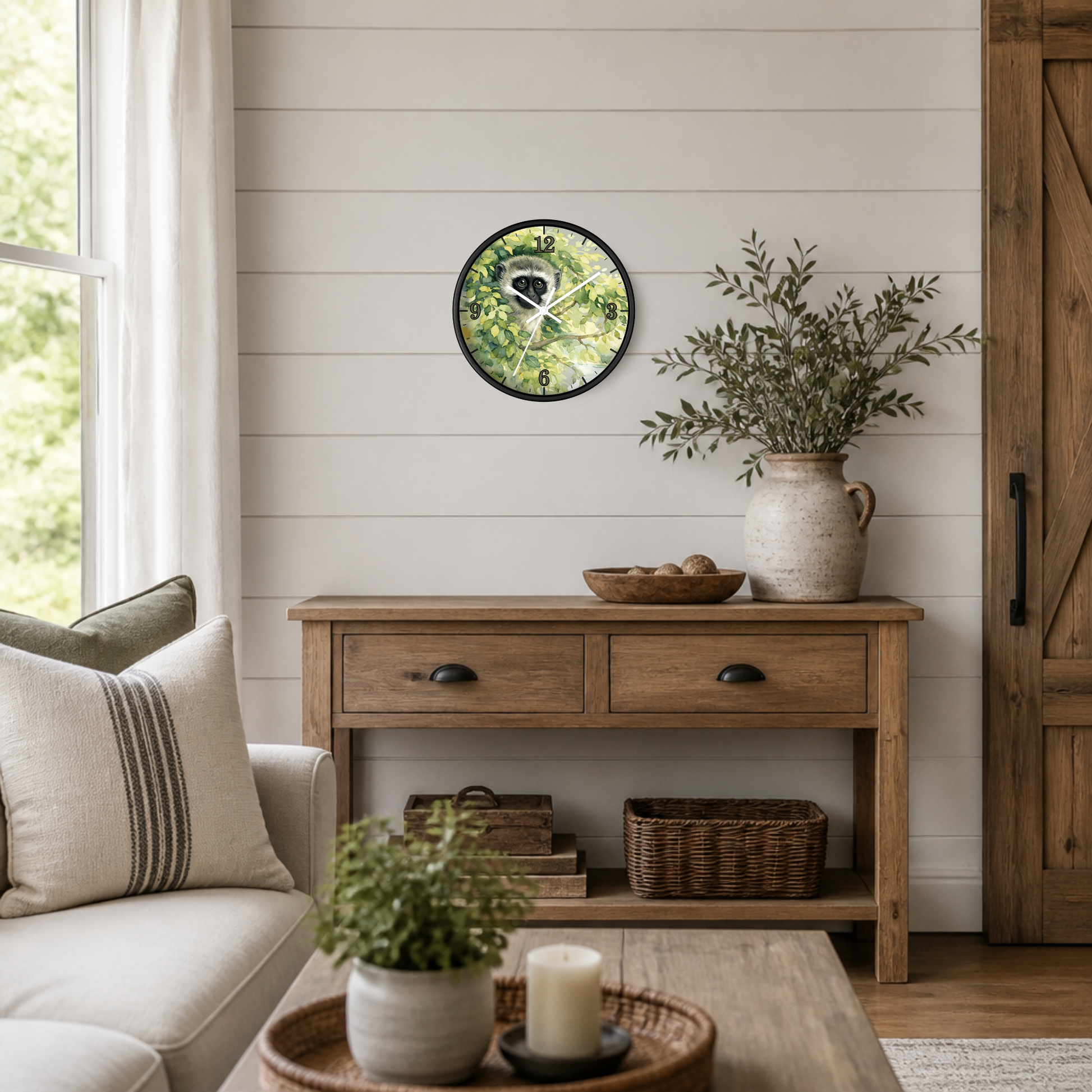 A round wall clock with a green forest pattern face and black frame, styled on a white shiplap wall above a rustic wooden console table in a cozy living room setting.