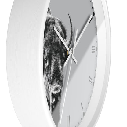 A white round wall clock with a black-and-white photographic print of a bison on the face, shown against a plain white background.