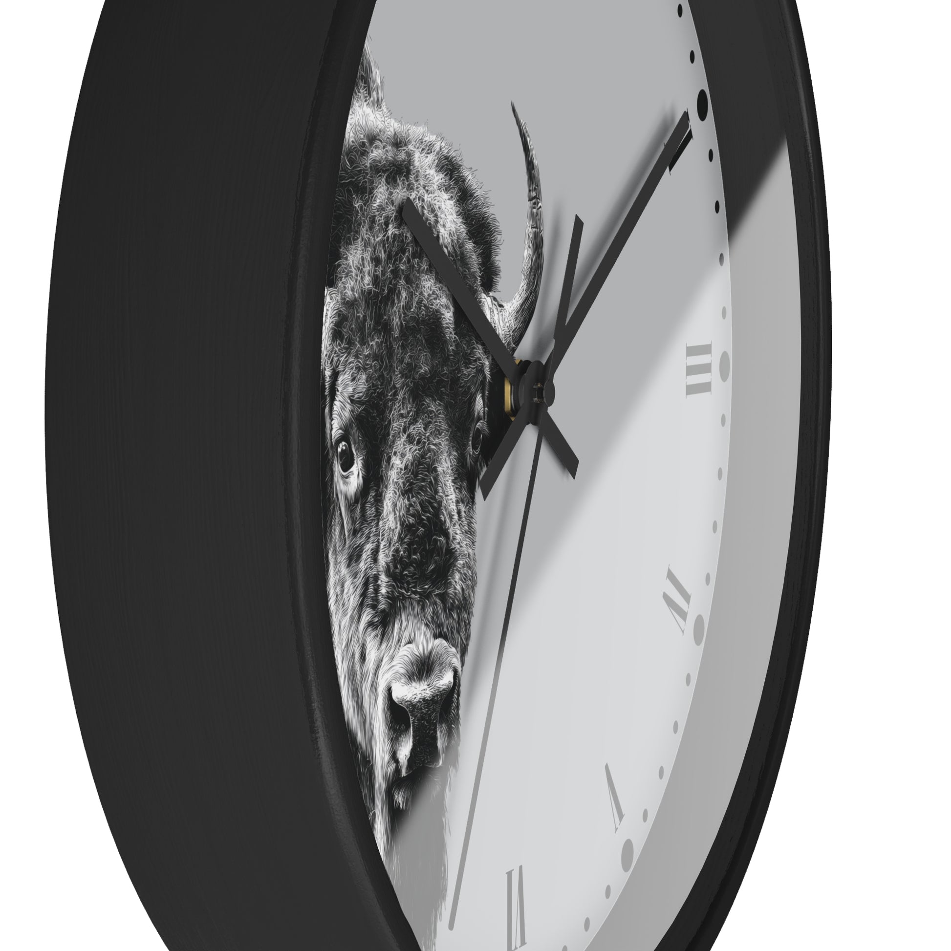 A round wall clock with a black frame and a white face featuring a black-and-white bull graphic. The clock is shown at an angle against a plain white background.