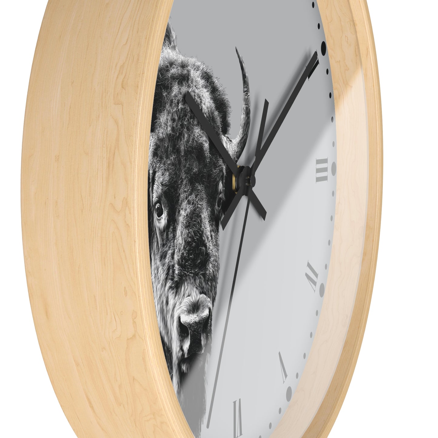 A round wall clock with a light natural wood frame and a white dial featuring a black-and-white close-up photograph of a bison. The clock has black hands and minimalist Roman numerals.
