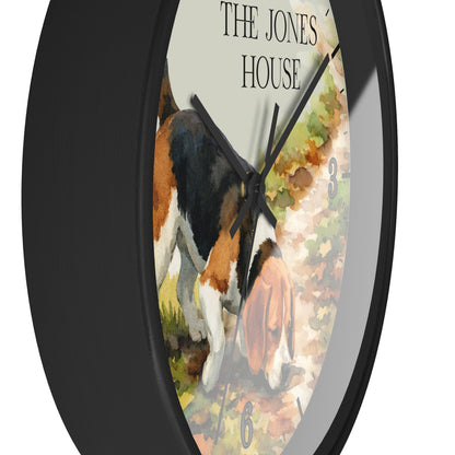 Round wall clock with a black frame and a printed dial showing a watercolor-style beagle dog scene with the text 'THE JONES HOUSE' at the top.