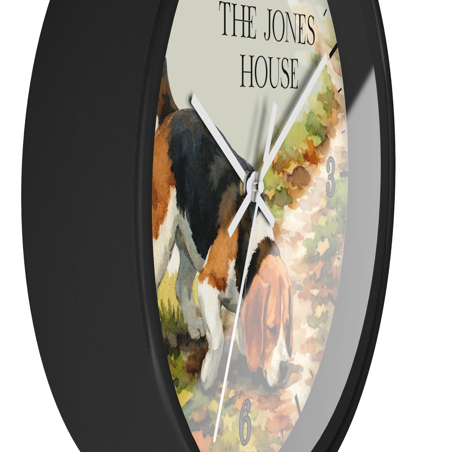 Round wall clock with a black frame and a printed dial showing a watercolor-style dog scene and the text 'THE JONES HOUSE'.