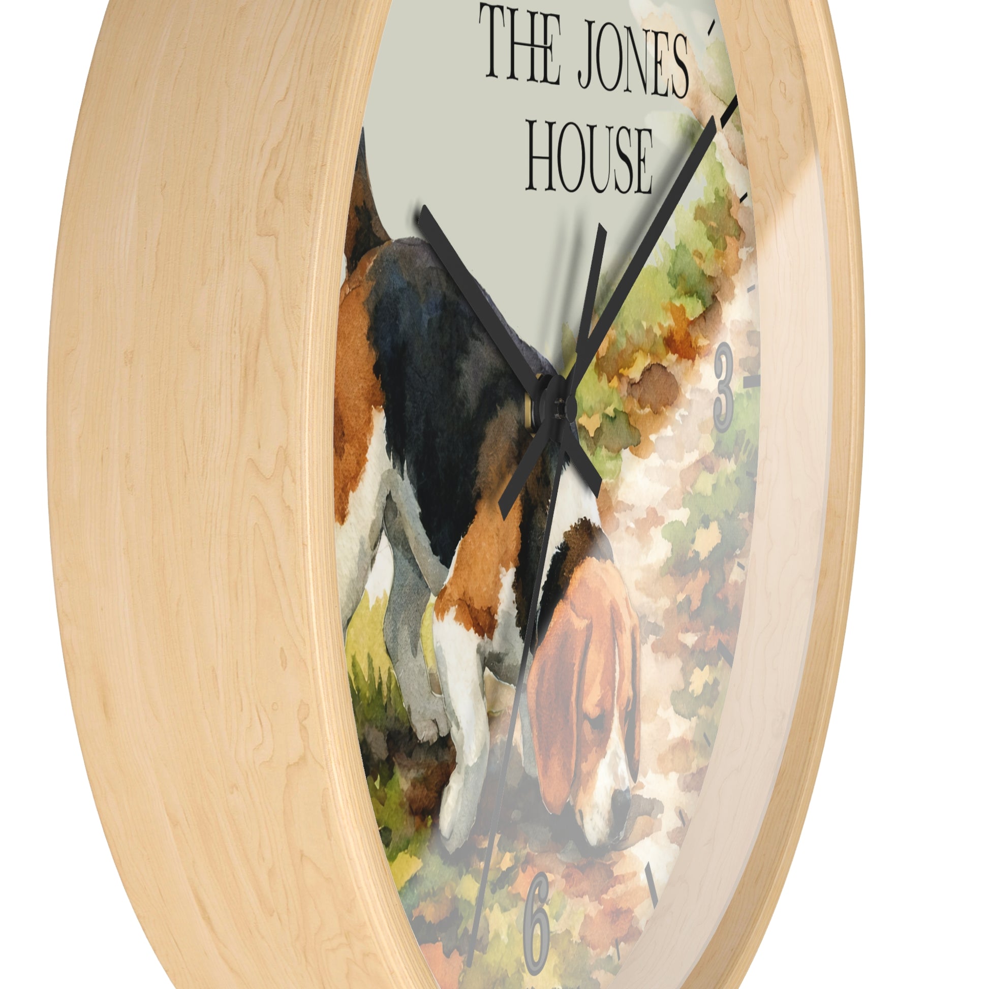 Round wall clock with a light natural wood frame and a printed illustration of a beagle dog on the face, with the text 'THE JONES HOUSE' at the top.