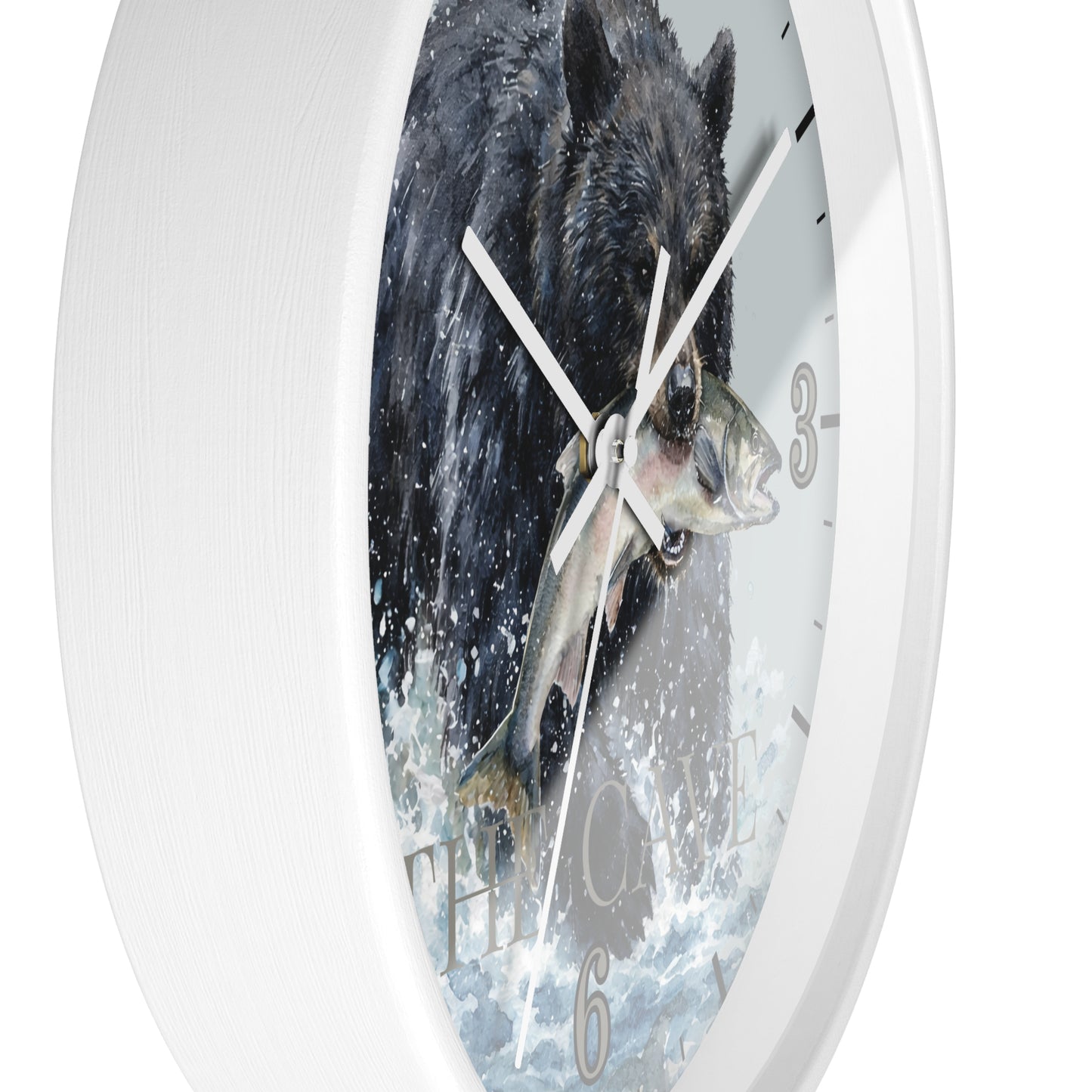 A white round wall clock featuring a printed design of a black bear catching a fish in splashing water, with white hands and gray Arabic numerals.
