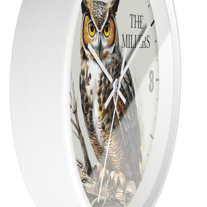 A white round wall clock featuring a detailed illustration of a great horned owl on the face, with black hands, black hour markers, and the text 'THE MILLERS' near the top right.