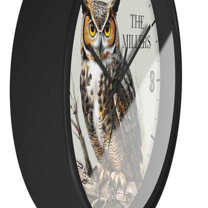 A round wall clock with a black frame and a white face featuring a large owl illustration and the text 'THE MILLERS'.