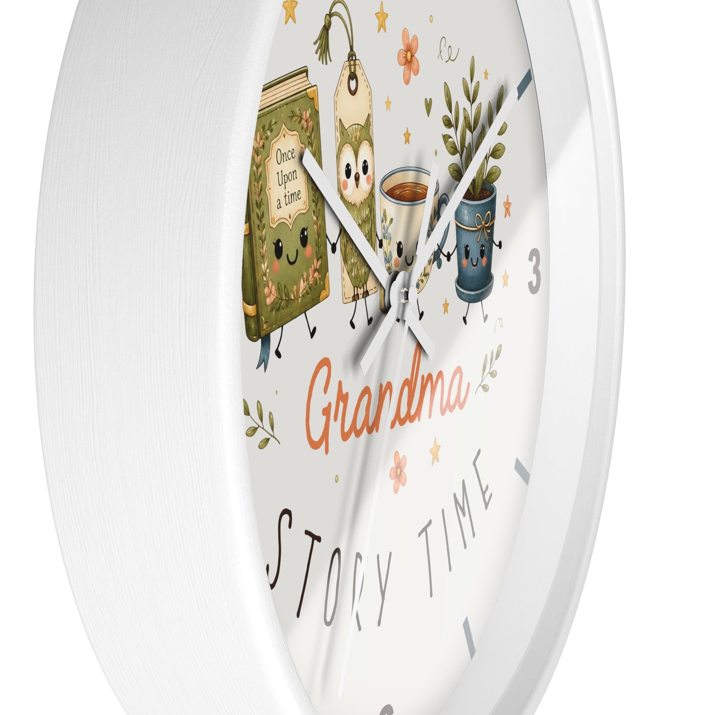A white round wall clock with a whimsical 'Grandma Story Time' illustration on the face, featuring cartoon tea bags, a book, a mug of coffee, and a potted plant.