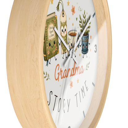 A round wall clock with a light natural wood frame and a white face featuring cartoon tea bags, a teacup, a potted plant, and the words 'Grandma' and 'Story Time'.