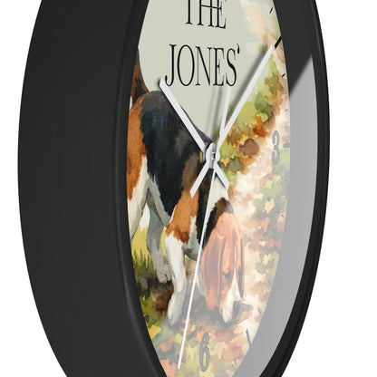 A round wall clock with a black frame and a printed watercolor-style face showing a beagle dog on a path, with the text 'THE JONES' at the top and small gray numbers for hours.