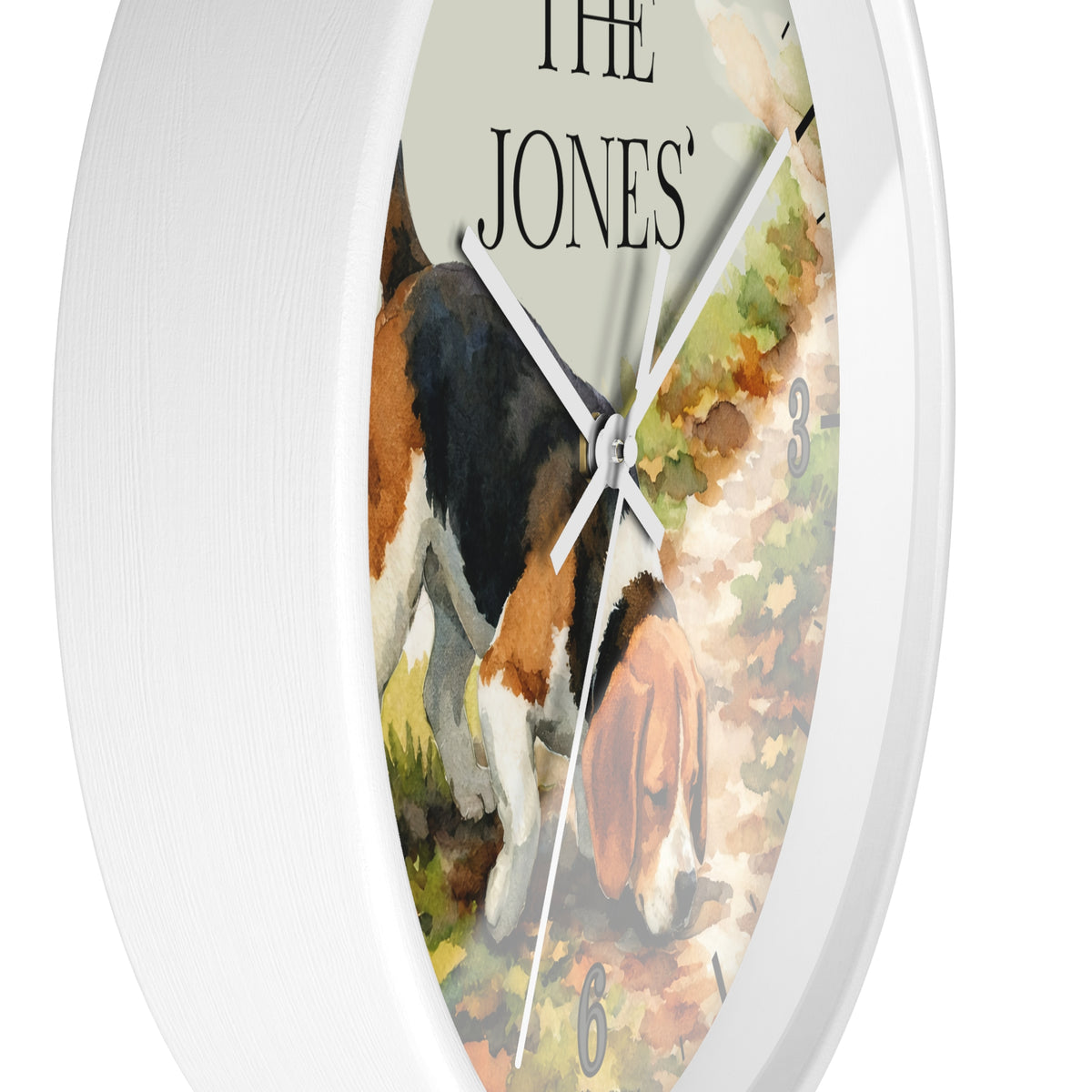 Round wall clock with a white frame and a printed watercolor-style dog illustration on the face, with the text 'THE JONES' at the top and small numeral markers around the dial.