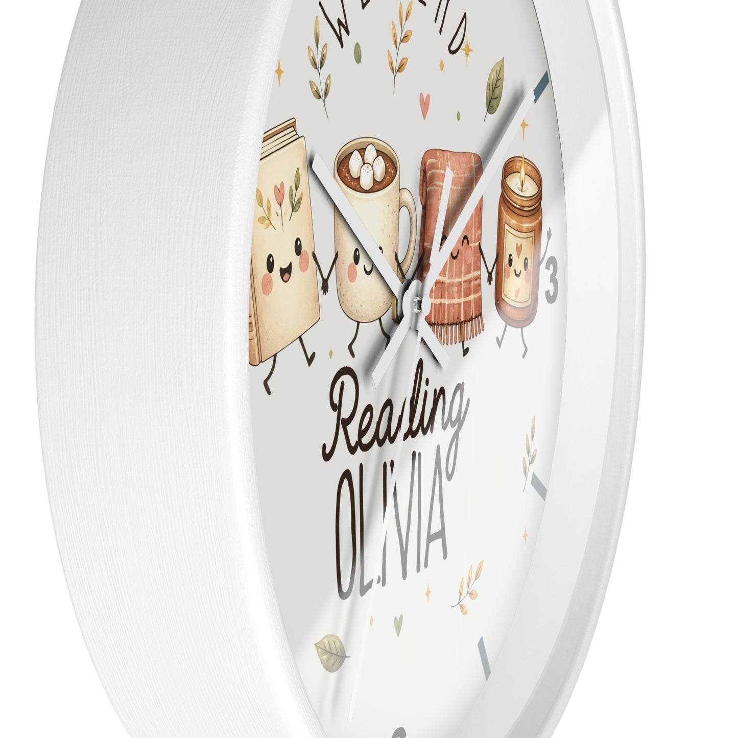 A round white wall clock with a whimsical illustration of reading-themed characters on the face, including a book, a mug with marshmallows, a slice of toast, and a candle jar. The words 'Reading OLIVIA' are printed on the dial.