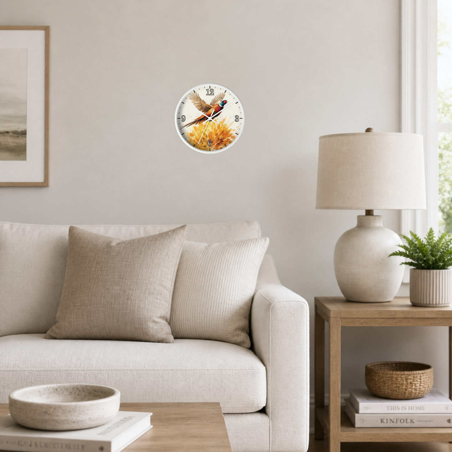 A round wall clock featuring a vintage-style illustration of a fox sitting on a log, mounted on a light gray wall in a modern living room setting with a sofa, side table, and lamp.