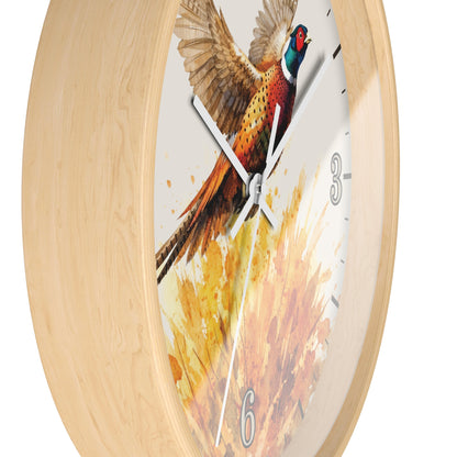 A round wall clock with a light natural wood frame and a printed pheasant artwork on the face. The clock has white hands, black hour markers, and numerals 3, 6, and 9 in a gray font, shown against a plain white background.