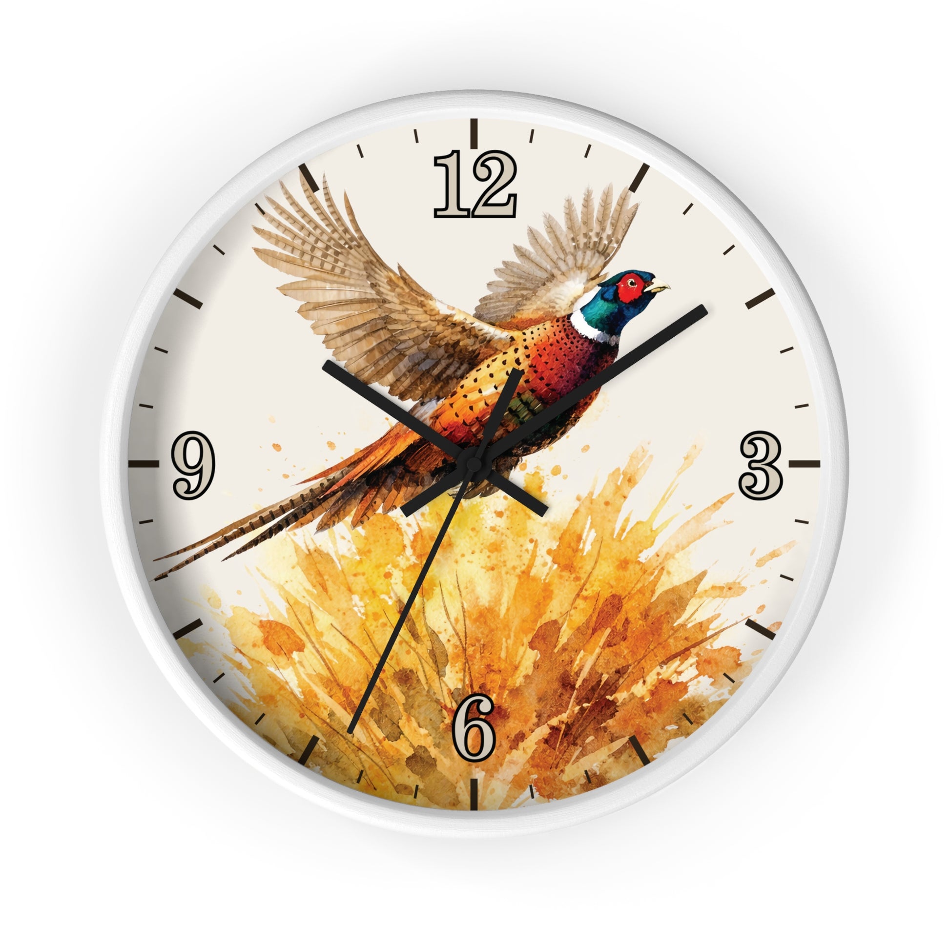 A round wall clock with a white frame and a printed design of a pheasant bird flying over a golden splash of watercolor, shown on a plain white background.