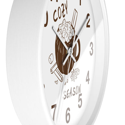 A white round wall clock with a cozy holiday design, featuring a brown mug filled with hot cocoa and cinnamon sticks, with the words 'COZY' and 'SEASON' on a clean white background.