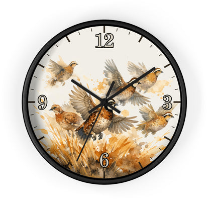 Round wall clock with a black frame and a watercolor-style bird illustration on the face, featuring brown and beige birds over a warm tan background with black numerals and hands.