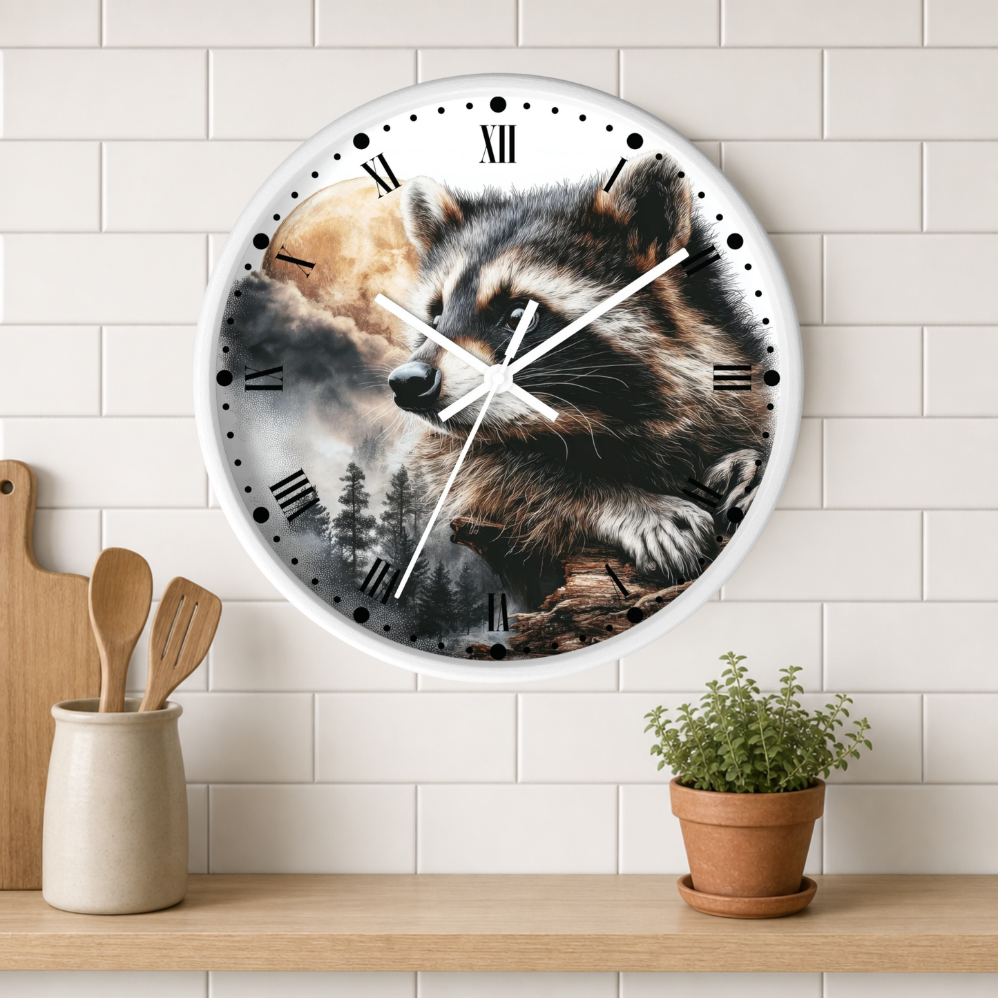 A round wall clock with a raccoon and forest scene printed on the face, mounted on a white subway-tile wall above a wooden shelf with kitchen utensils and a small potted plant.