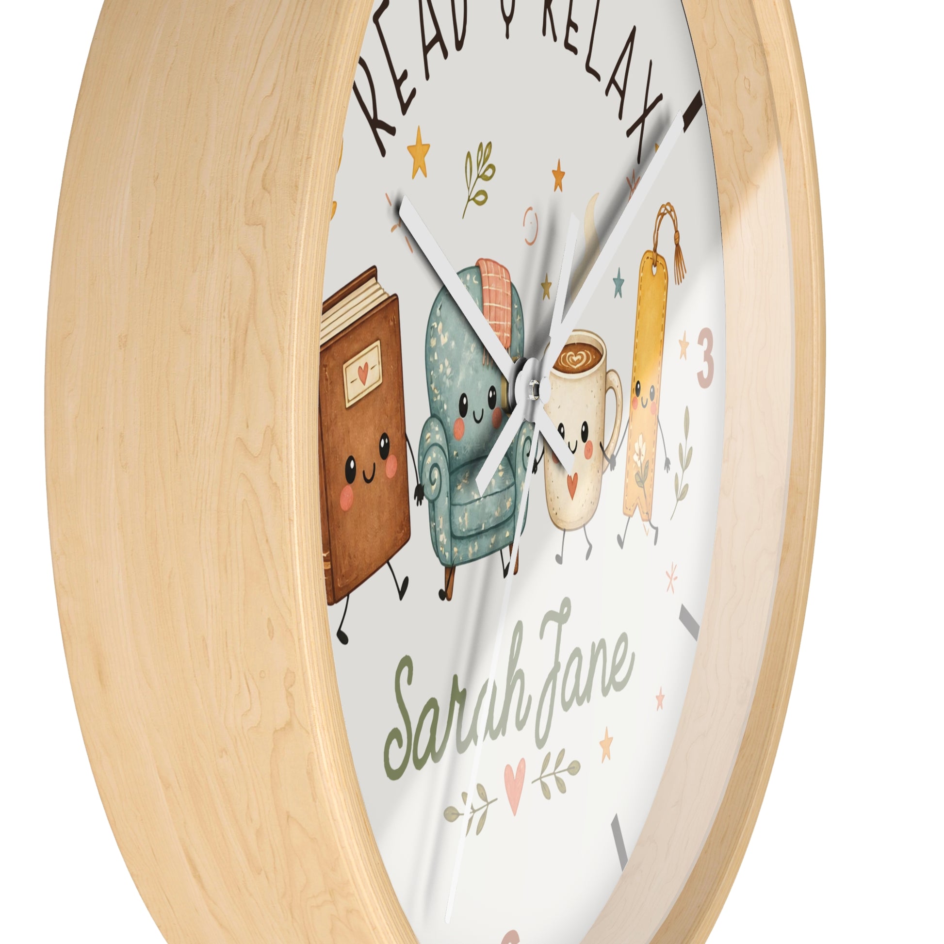 A round wall clock with a light natural wood frame and a white face featuring cute illustrated characters and the words 'READ & RELAX' and 'Sarah Jane'.