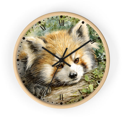 A round wall clock with a light wood frame and a printed face featuring a close-up illustration of a red panda resting on a log. The clock has black Roman numerals and black clock hands, shown against a plain white background.