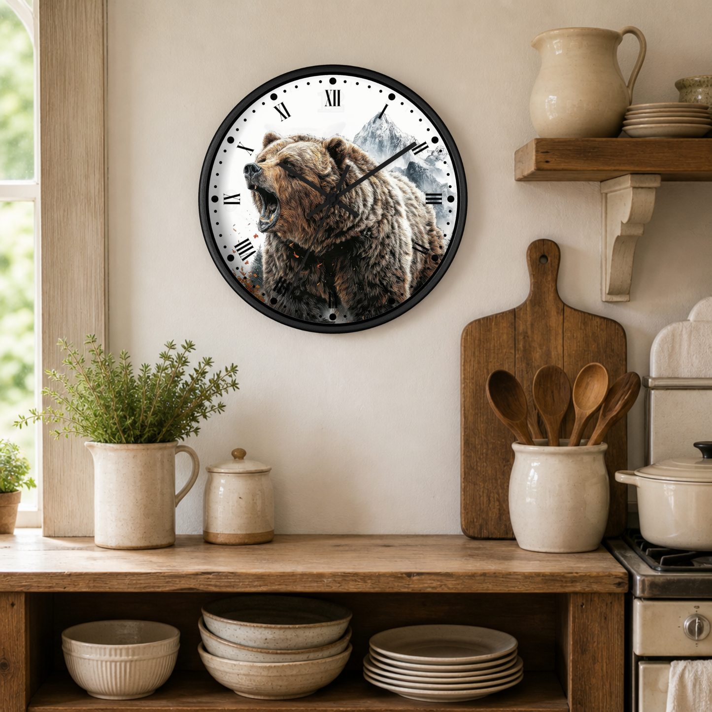 A round wall clock with a black frame hangs on a beige kitchen wall above a wooden shelf. The clock face features a detailed illustration of a grizzly bear in the center, surrounded by black Roman numerals.