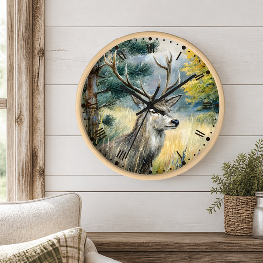 A round wall clock with a light wood frame hangs on a white shiplap wall above a wooden mantel. The clock face features a detailed painting of a gray deer with antlers in a forest setting.