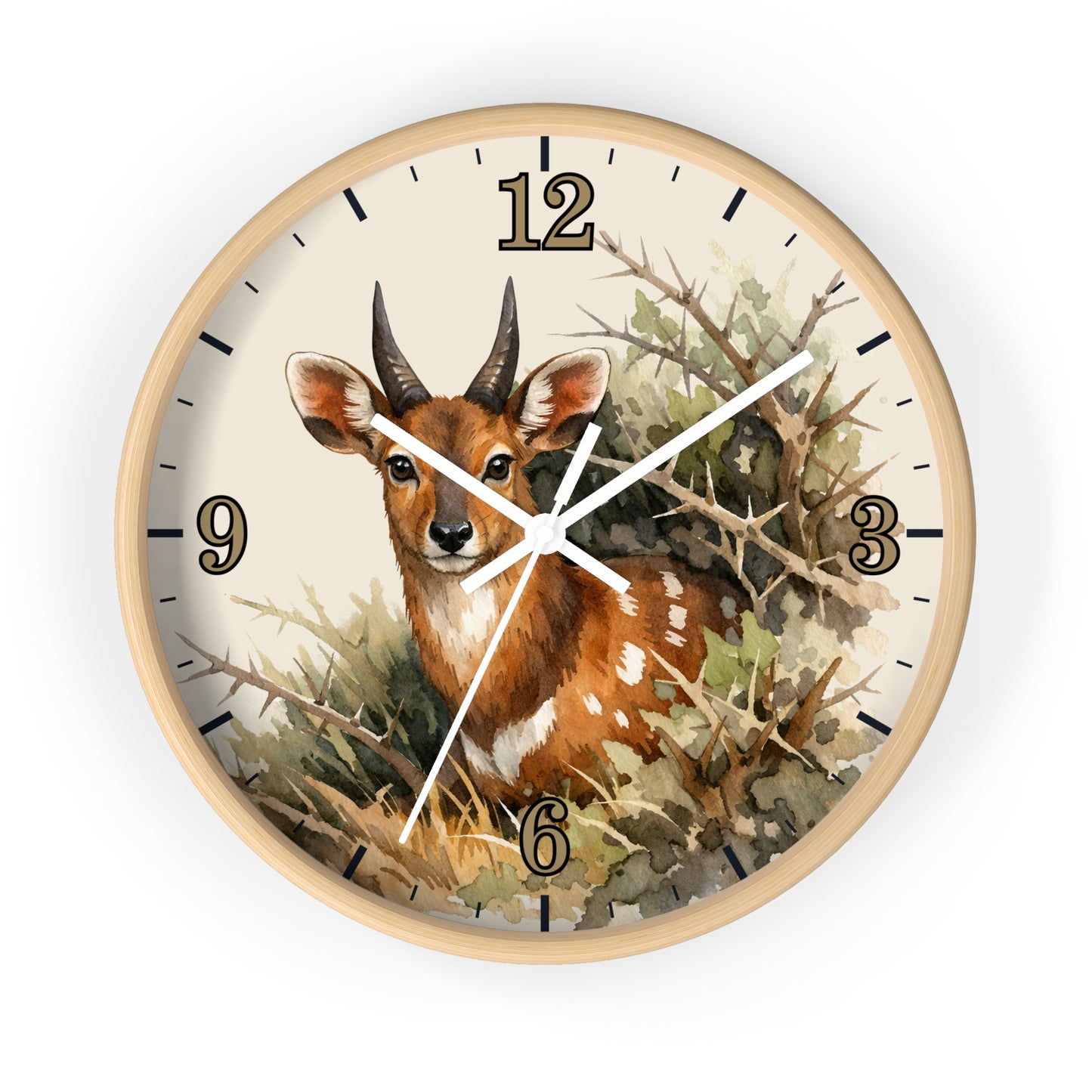 Round wall clock with a light wood frame and a watercolor-style illustration of a brown antelope deer among branches and foliage on the clock face. The numbers 12 through 6 are visible, along with white clock hands.