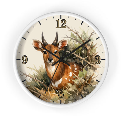 Round wall clock with a white frame and a printed illustration of a brown deer among branches and foliage on the face, with black numerals and hands on a white background.