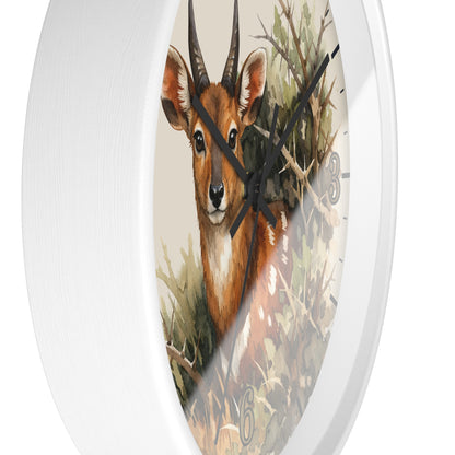 Round wall clock with a white frame and a printed illustration of a brown antelope or deer among branches and foliage on the clock face.