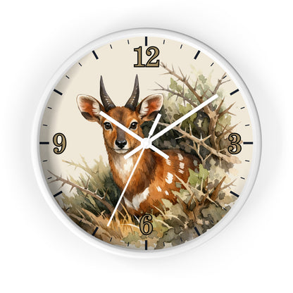 Round wall clock with a white frame and a printed illustration of a brown antelope deer among branches and foliage. The clock face is cream with black numerals and hands.