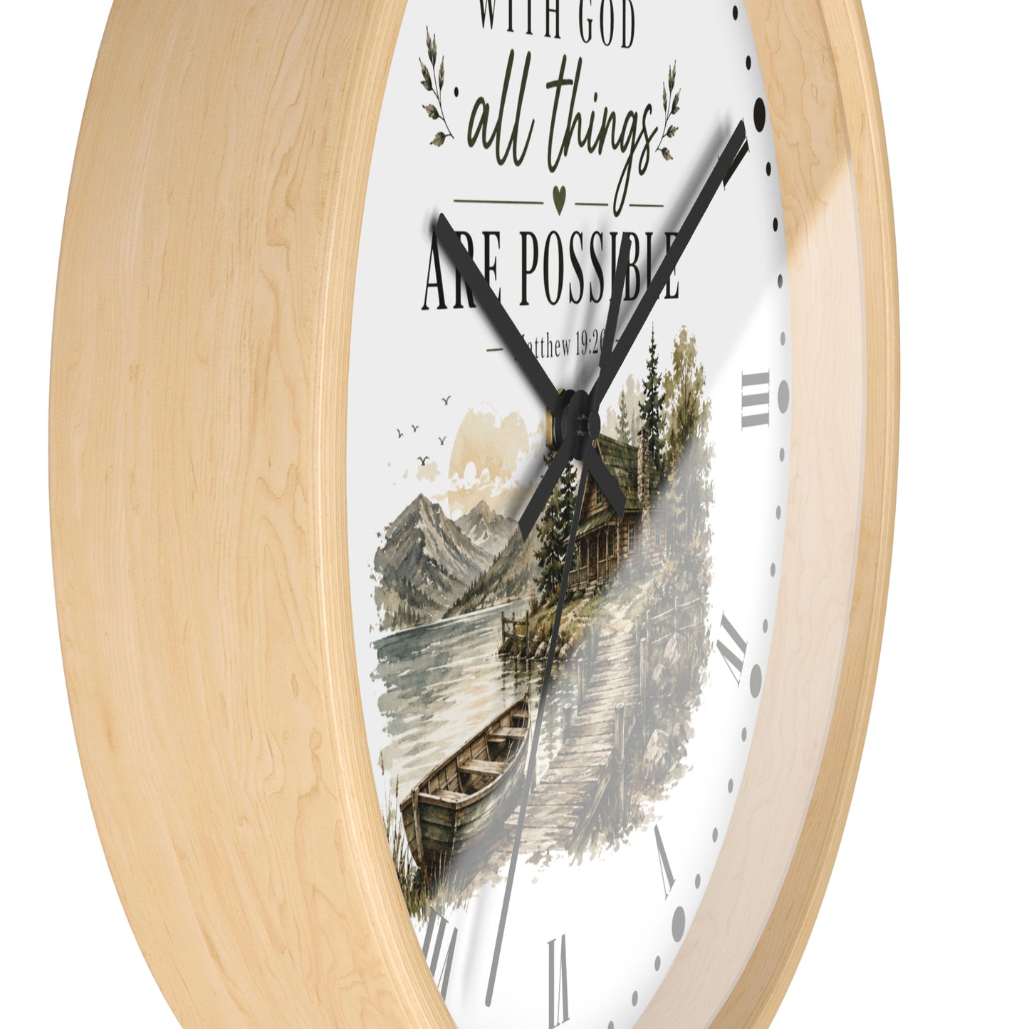 A round wall clock with a light natural wood frame and a white face featuring a scenic lake and cabin illustration, along with the text 'WITH GOD all things ARE POSSIBLE' and 'Matthew 12:13'.
