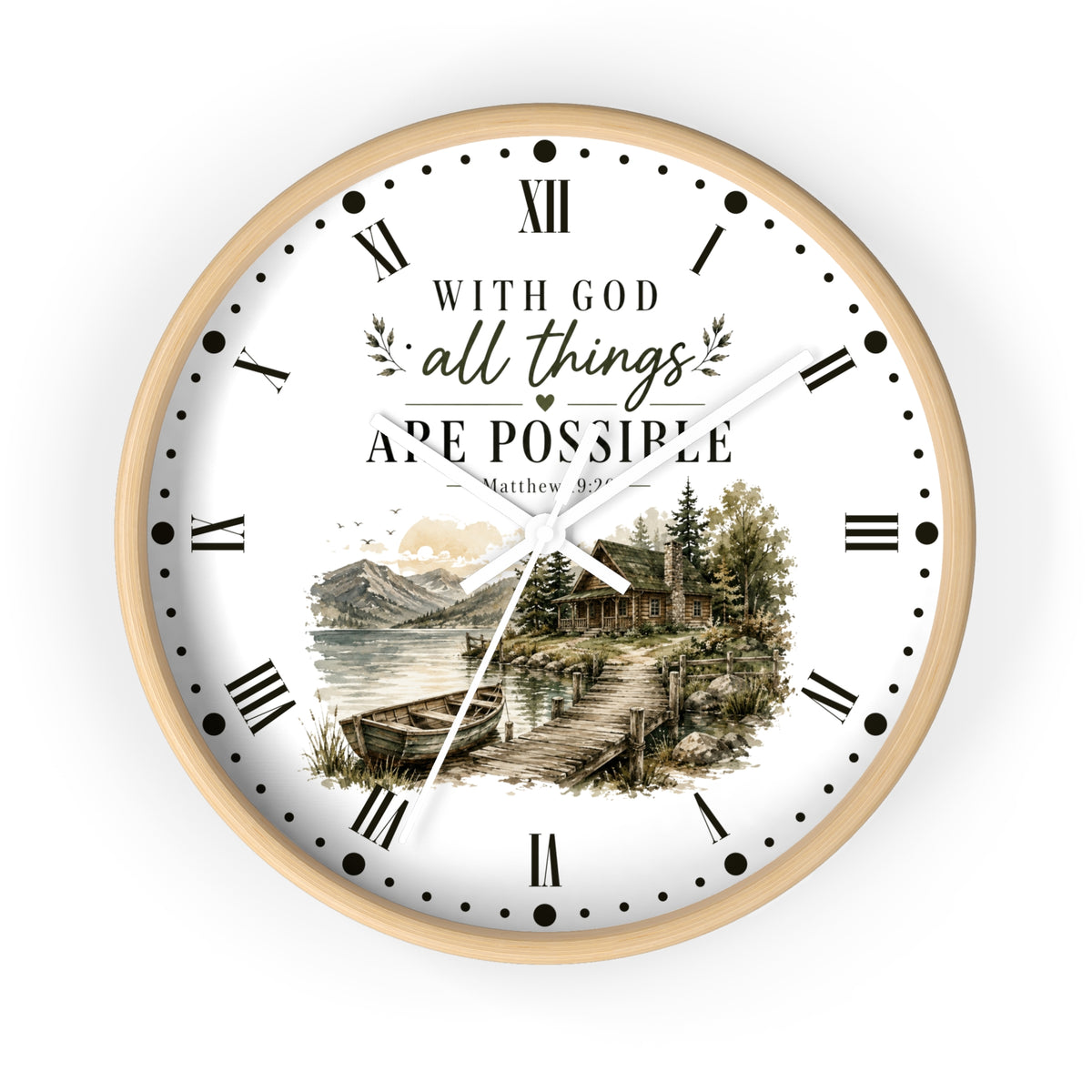 A round wall clock with a light wood frame and a white face featuring the text 'WITH GOD all things ARE POSSIBLE Matthew 19:26' above a scenic illustration of a cabin by a lake. The clock uses black Roman numerals and hands on a clean white background.