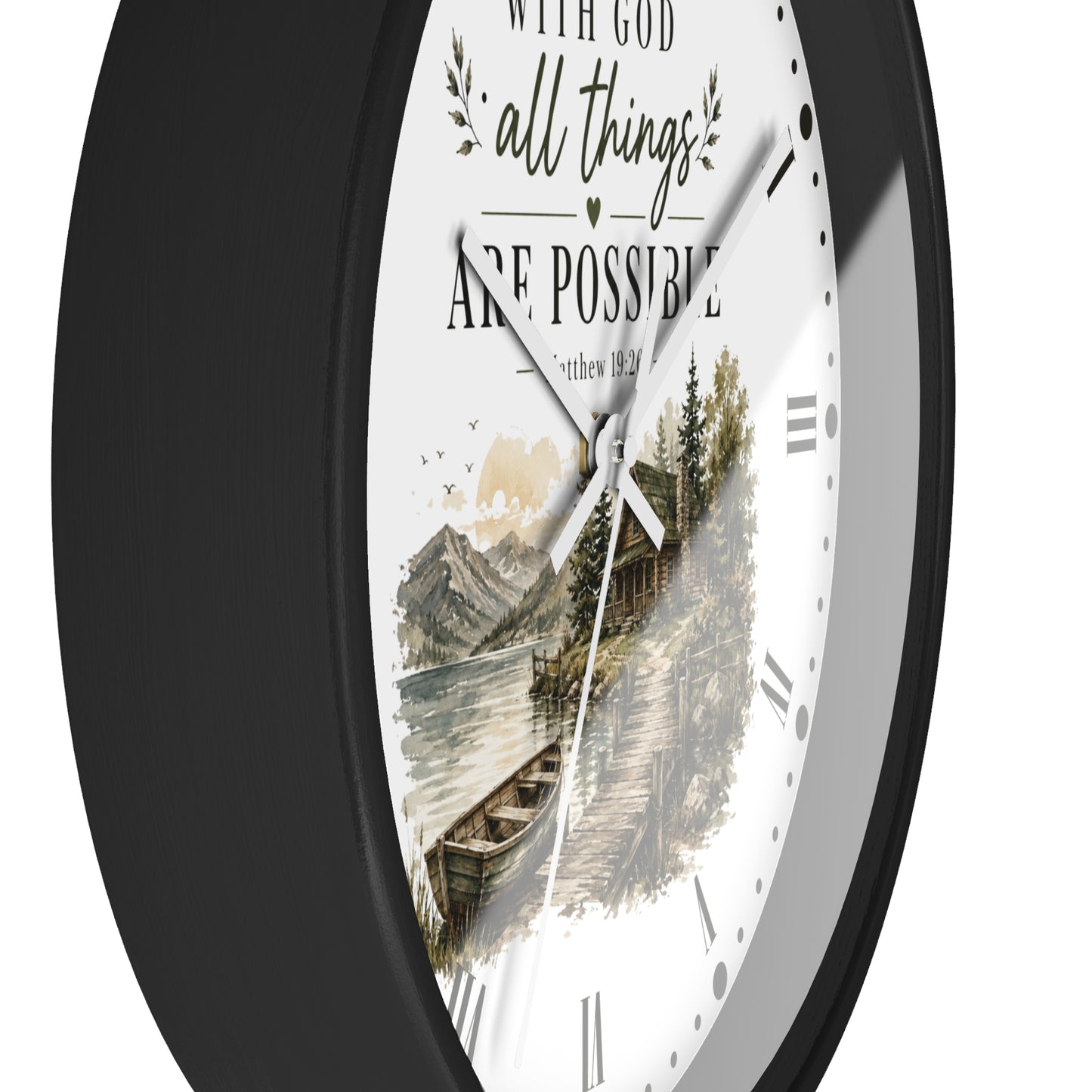 A round wall clock with a black frame and a white face featuring the inspirational quote 'WITH GOD all things ARE POSSIBLE' above a scenic illustration of a cabin by the water.