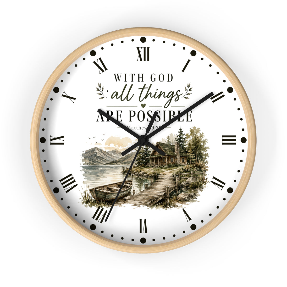 A round wall clock with a light wood frame and a white face. The clock face features black Roman numerals, black hands, and a scenic illustration of a lakeside cabin with mountains and trees.
