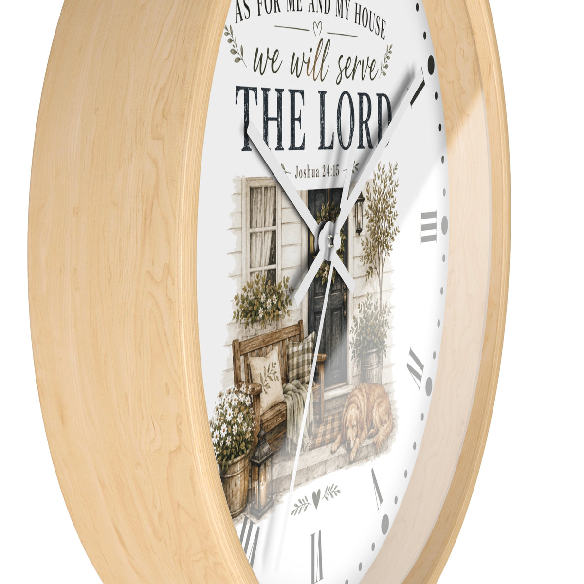 Round wall clock with a light natural wood frame and a white face featuring a rustic house illustration and the text 'AS FOR ME AND MY HOUSE we will serve THE LORD'.